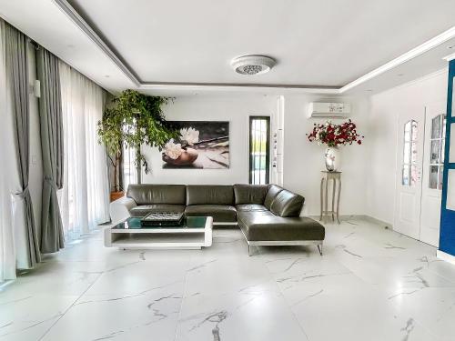 a living room with a couch and a table at Paris Dream Villa in Villejuif