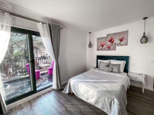 a bedroom with a bed and a large window at Paris Dream Villa in Villejuif