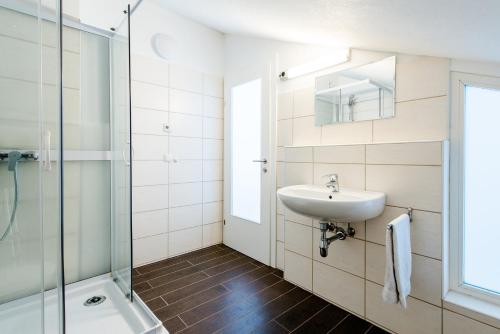 a bathroom with a sink and a shower at Chalet Vergissmeinnicht in Zell am See