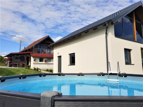 a house with a swimming pool in front of a house at Kuća za odmor Villa Cesarica - Zagreb in Graberje Ivanićko