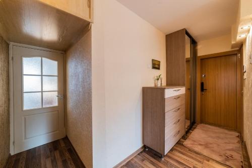 a room with a closet and a door with a drawer at A.P. Apartment in Šiauliai