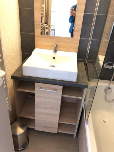 a bathroom with a white sink and a mirror at L ADRET - Duplex 6 pers 2 chambres - Belle Plagne PARADISKI in La Plagne Tarentaise