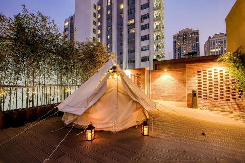 a tent is set up on a patio with lights at Meriden M Hotel Beijing - Sanlitun Tuanjiehu Subway Station in Beijing