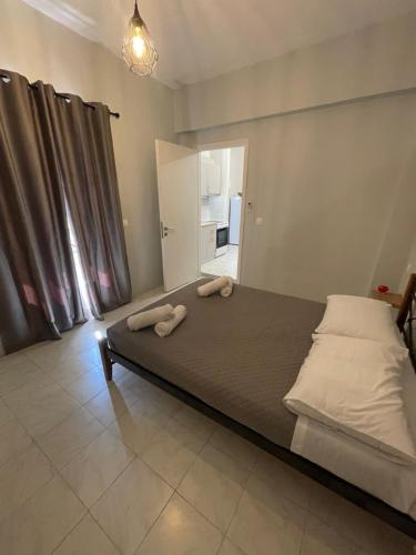 a bedroom with a bed with two towels on it at Sidari Centre Apartments in Sidari