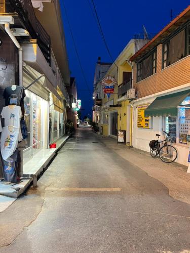 an empty street in a town at night at Sidari Centre Apartments in Sidari