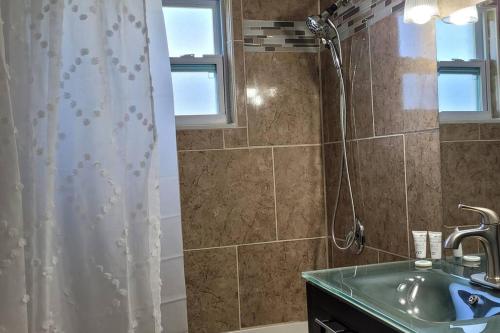 a bathroom with a shower and a sink at Cozy By The Sea - Hutchinson Island - A in Fort Pierce