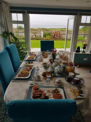 a long table with plates of food on it at Sunrise view in Ballina