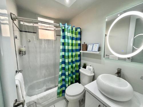 a bathroom with a shower and a toilet and a sink at Pearl of the East in Ceiba an entire Penthouse with Ocean View in Santa Maria