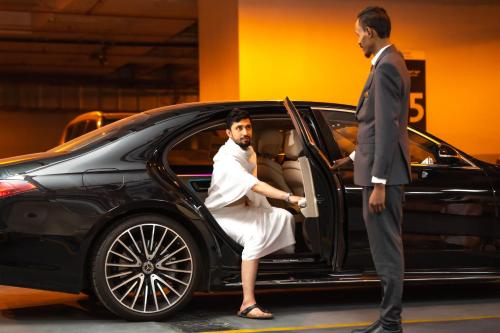 a man is getting out of a car at Makkah Clock Royal Tower, A Fairmont Hotel in Makkah