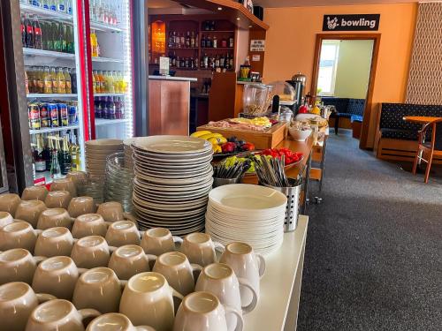 a store with plates and cups and dishes on a table at Hotel Aldo in Uničov