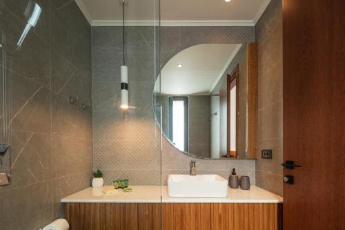 a bathroom with a sink and a mirror at Magical new luxury villa Camellia! in Kissamos
