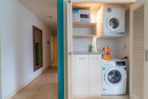 a small laundry room with a washer and dryer at Park view Avalon Apartment District 1 HCM City in Ho Chi Minh City