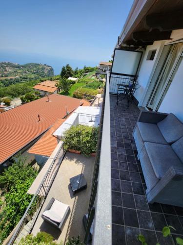 a balcony with a couch and chairs on a house at Valle degli Dei in Agerola