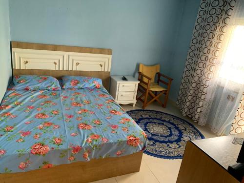 a bedroom with a bed and a desk and a chair at “Tek Riki” in Korçë
