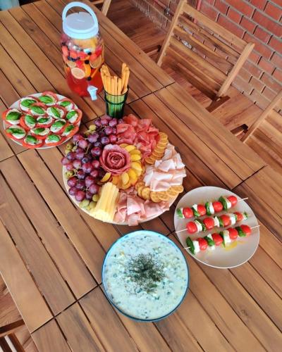 a table topped with plates of food on a wooden table at Kuća za odmor Villa Cesarica - Zagreb in Graberje Ivanićko
