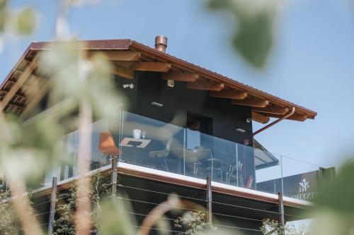 a building with a window with a person sitting in it at VINEHO in Barolo