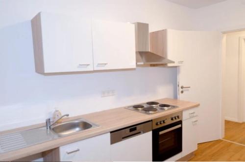 a kitchen with a sink and a stove top oven at Wohnung Bruchsal in Bruchsal