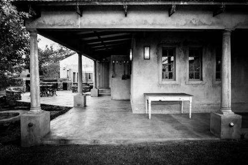 a pavilion with a table in front of a building at The Nutcracker Homestead in Venterskroon
