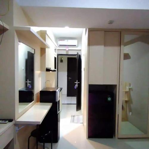 a room with a kitchen with a counter and a door at Andalemi Home Stay in Ciwidey