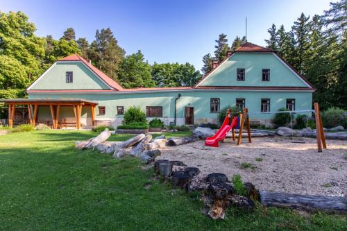 a house with a playground in front of it at Hájenka Budislav in Budislav