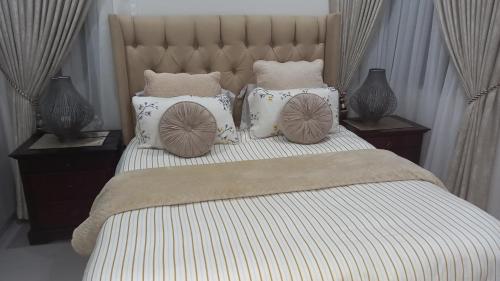 a bedroom with a large bed with pillows on it at KK'S Haven in Johannesburg