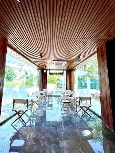 a dining room with tables and chairs in a building at Skeyndor Health & Resort in Na Jomtien