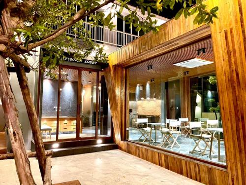 a building with a table and chairs in front of it at Skeyndor Health & Resort in Na Jomtien