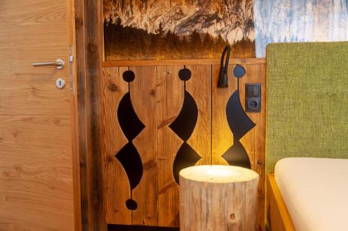 a room with a wooden door with a wooden stool at Biohof Oberwerkstatt in Obereggen