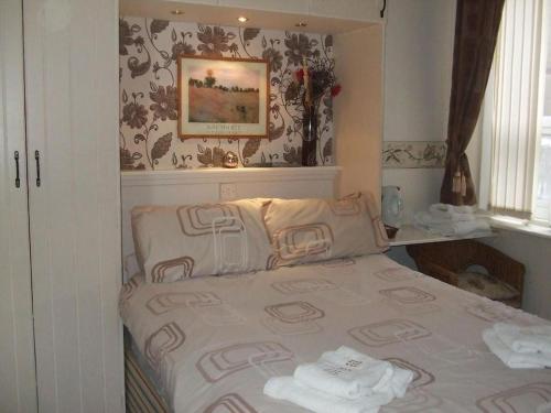 a bedroom with a bed with towels on it at Fern Villa Hotel - Albert Road in Blackpool