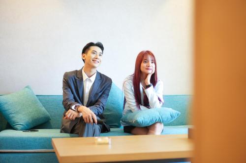 a man and a woman sitting on a couch at SENNA SUNSHINE INTERNATIONAL HOTEL in Sihanoukville