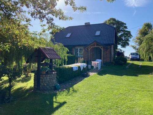 a small house with a table in front of it at Kolonia u Jasia Rajgród in Rajgród