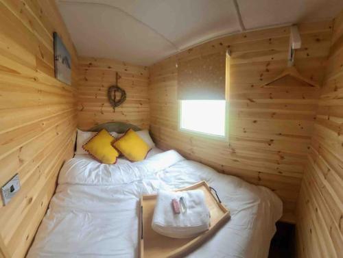 a room with a bed in a wooden cabin at Runaway Northumberland in Morpeth