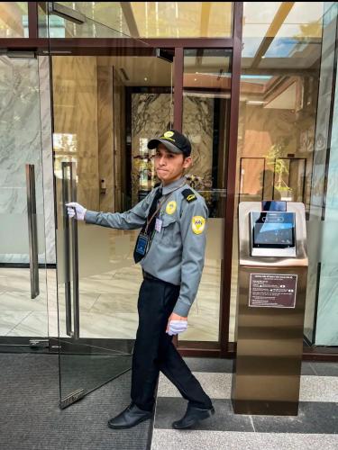 a police officer standing in front of a building at THE METROPOLE Apartment Complex OPERA-GALLERIA-CREST in Ho Chi Minh City