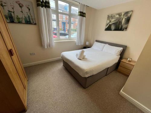 a bedroom with a bed and a window at Alexander Apartments South Shields 2 in South Shields