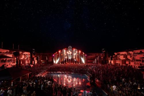 a crowd of people in front of a stage at night at The Unexpected Ibiza Hotel - Ushuaïa Club entrance included in Playa d'en Bossa