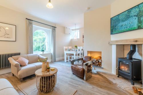 a living room with a couch and a fireplace at Wallhope Retreat in Chepstow