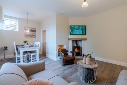 a living room with a couch and a fireplace at Wallhope Retreat in Chepstow