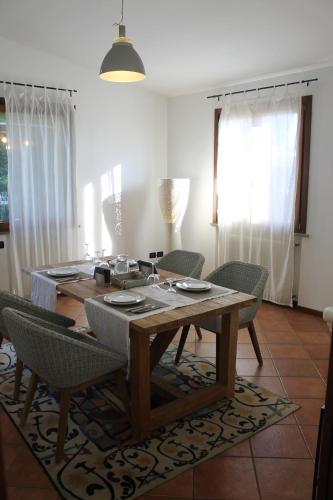 a dining table and chairs in a living room at Hebe Home Riccione in Misano Adriatico