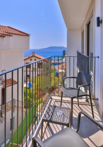 a balcony with two chairs and a view of the ocean at Kas Athena Hotel in Kas