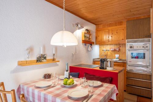 a kitchen with a table with a bowl of fruit on it at Rustico Stock - Happy Rentals in Lugano