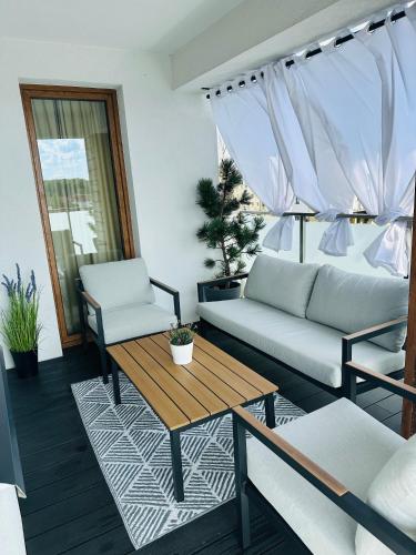 a living room with a couch and a table at Premium Apartament Polna Szczecinek in Szczecinek