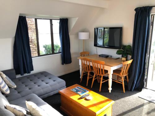 アカロアにあるWharfside Apartmentのテーブルとソファのあるリビングルーム