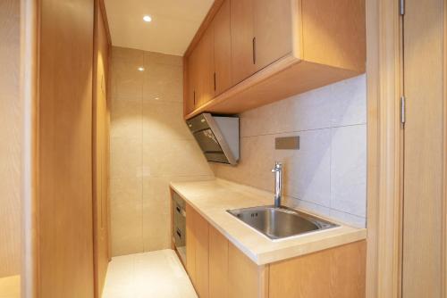 a small kitchen with a sink and a sink at SENNA SUNSHINE INTERNATIONAL HOTEL in Sihanoukville