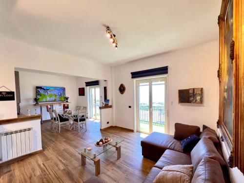 a living room with a couch and a table at Carrubba's luxury home in San Giovanni la Punta