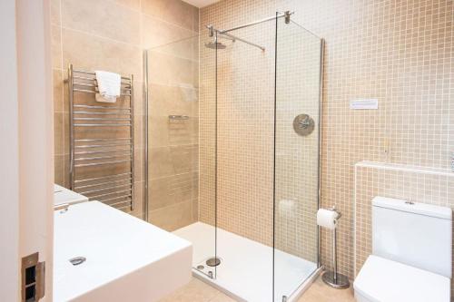 a bathroom with a shower and a toilet and a sink at Waters Edge 05, Amaranth Lodge - P in South Cerney