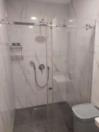 a shower with a glass door in a bathroom at Soho City 708B in Bar