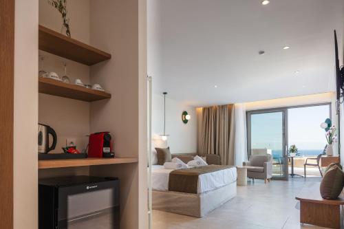 a bedroom with a bed and a living room with a view at San Antonio Boutique Hotel in Hersonissos