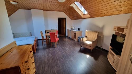 a room with a bed and a table and chairs at Villa Theresa Apartments in Mainburg