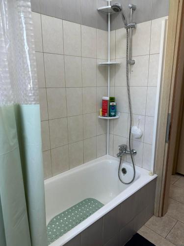 a bathroom with a shower and a bath tub at Sidra's Apartment in Paralimni