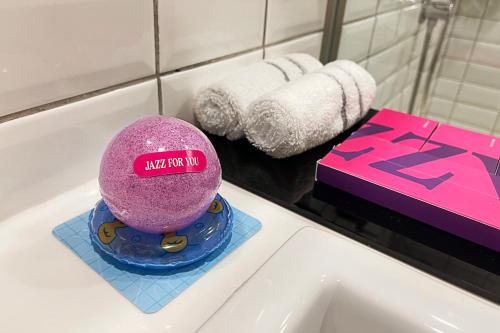 a pink ball sitting on top of a bathroom sink at Jazz Hotel Penang in George Town